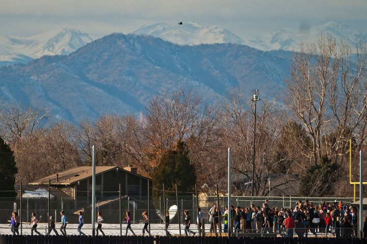 Students walk out of Arapahoe High School, after a student opened fire in the school in Centennial, Colorado