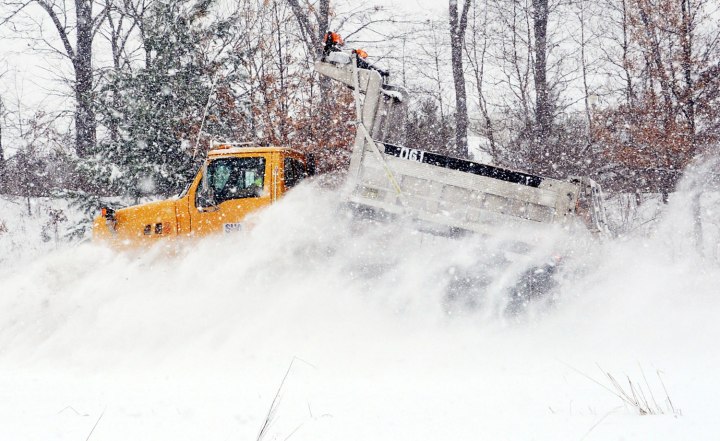 A large snowplow sends snow flying as it clears an eastbound lane of U.S. 340 near Frederick, Md. on Dec. 8, 2013.