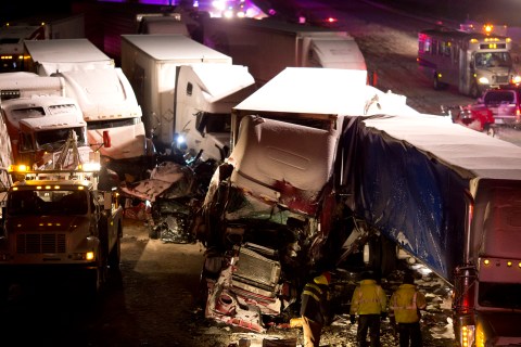 Emergency crews work at the scene of a massive pileup involving more than 40 vehicles, many of them semitrailers, along Interstate 94 Thursday afternoon, Jan. 23, 2014 near Michigan City, Ind.