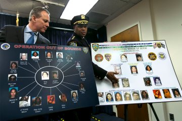 From left: New York Attorney General Eric Schneiderman and New York City Police Dept. Chief of Department Philip Banks display a chart relating to the Super Bowl "party packs" at a news conference, in New York City, on Jan. 30, 2014.