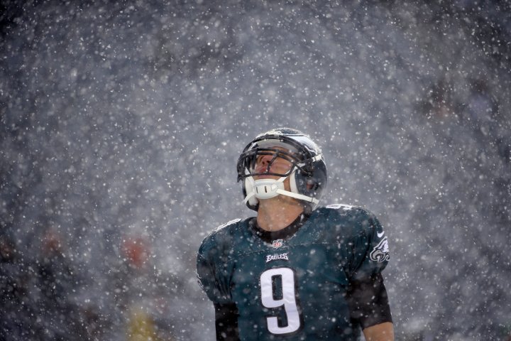 Philadelphia Eagles' Nick Foles warms up as snow falls before an NFL football game against the Detroit Lions, Dec. 8, 2013, in Philadelphia. 
